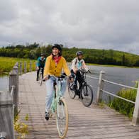 People cycling the Acres Lake Floating Boardwalk in Co Leitrim
