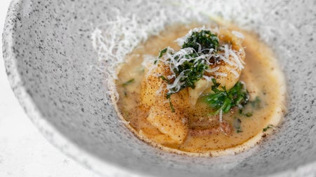Small dish of food with garnishing in a speckled grey bowl