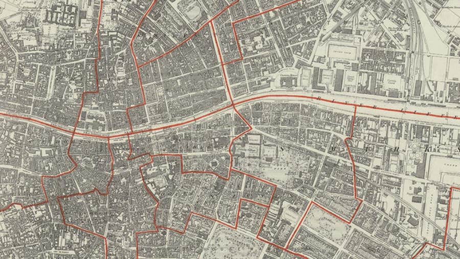 A detailed historic map of Dublin showing tight streets, buildings and districts in monochrome, with bold red boundary lines marking valuation areas. The map has an aged, archival look ideal for genealogy and family‑history research.