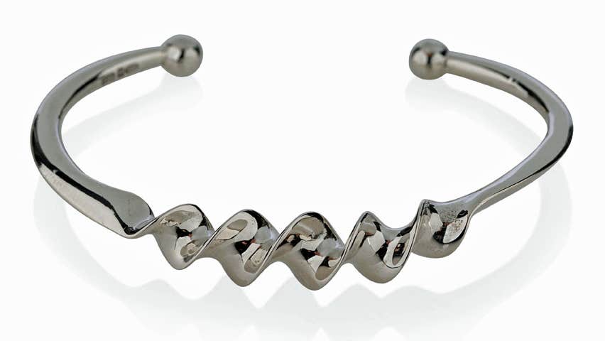 A silver ribbon bangle form the Torc Collection
