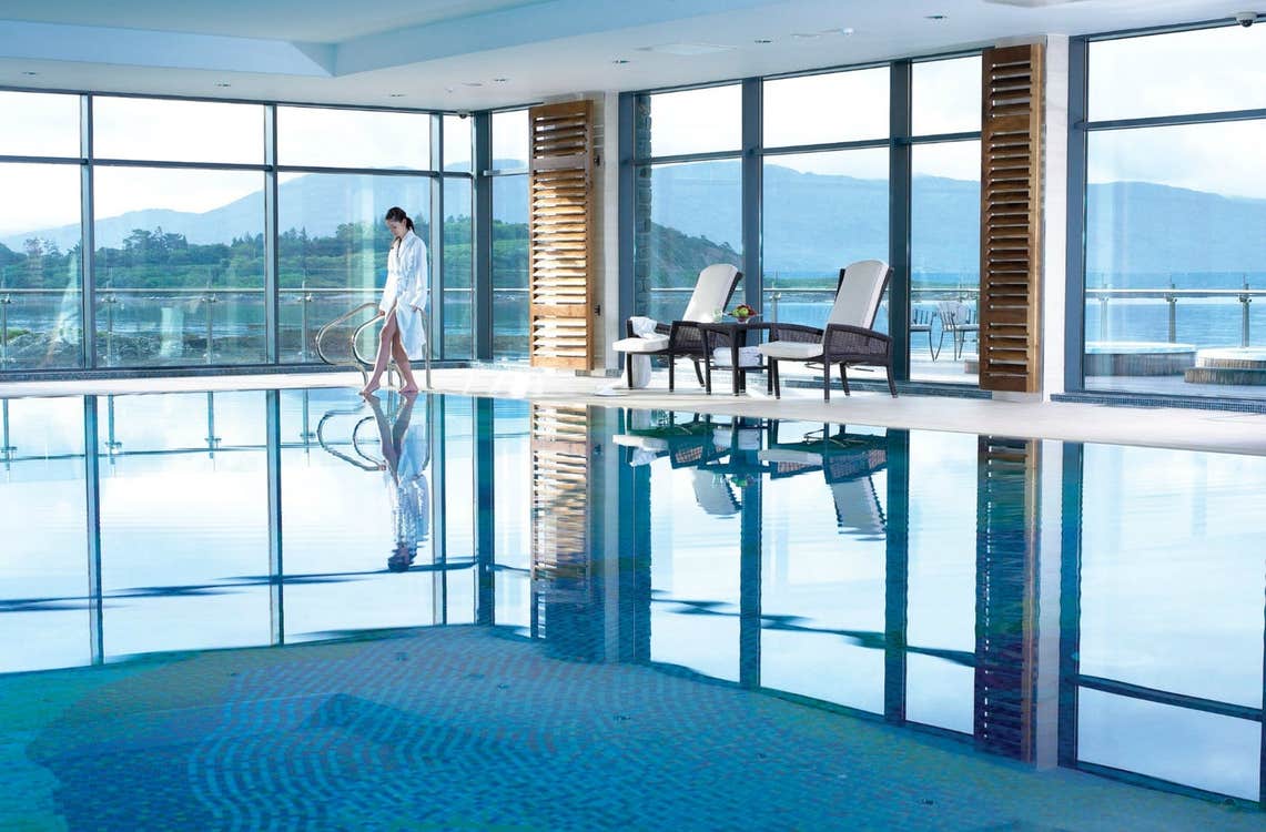 An enclosed swimming pool with floor to ceiling windows