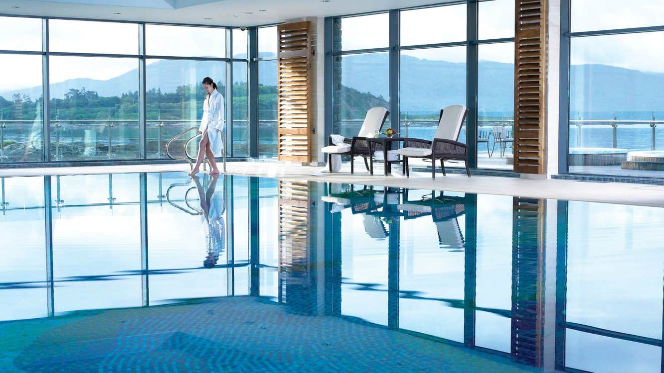 An enclosed swimming pool with floor to ceiling windows