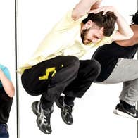 3 people in crouched position with arms covering their lowered heads.