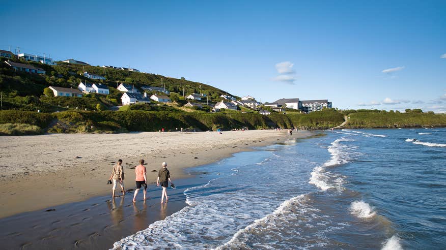People walking on Inchydoney Beach in Clonakilty, Co Cork