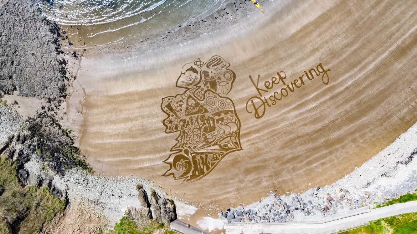 The Keep Discovering logo overlaid on golden sand at Kilmurrin Beach, County Waterford