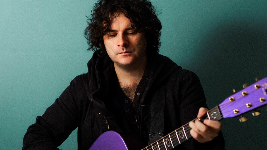Paddy Casey - a man looking down at a guitar he is playing