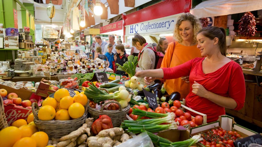 Two women shopping for fruit and veg at the English Market
