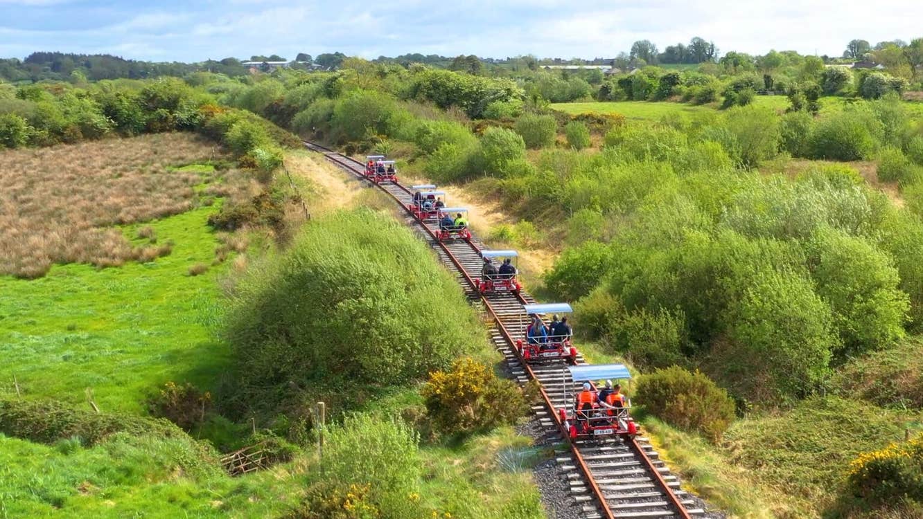 Aerial view of railbikes travelling along the old railway line with Mayo Velorail