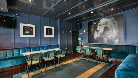 A subdued coloured room with comfortable seating and tables