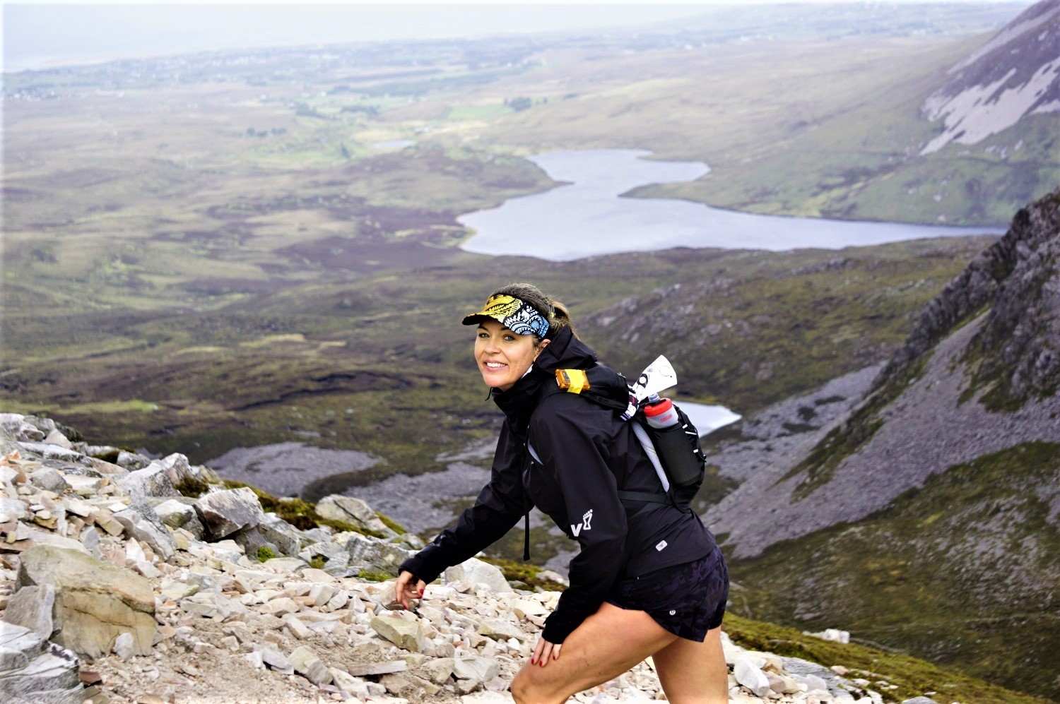 A female Seven Sisters participant ascending the scree slopes of Errigal as part of the 30km race.