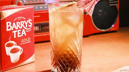 A retro Long Island Iced Barry's Tea cocktail beside a vintage boombox