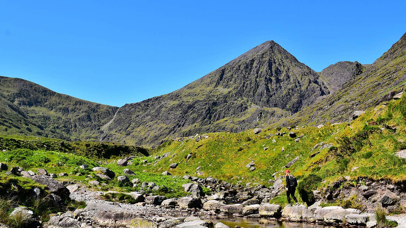 A hiker climbing Carrauntoohil in County Kerry