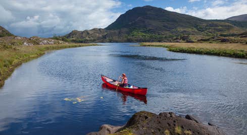 A person canoeing the lakes of Killarney in County Kerry.