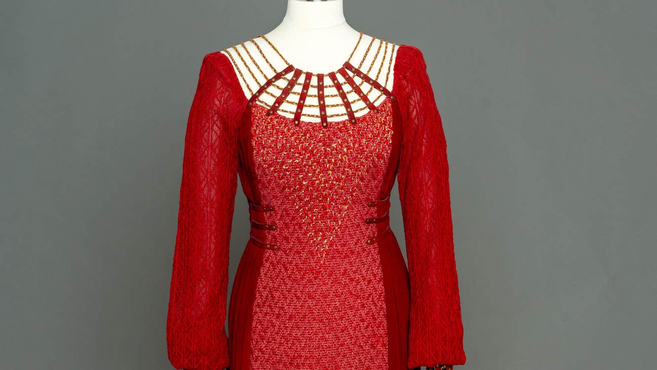 Vikings TV series - Katheryn Winnick as Lagertha. Top view of long, fitted red dress on a mannequin.