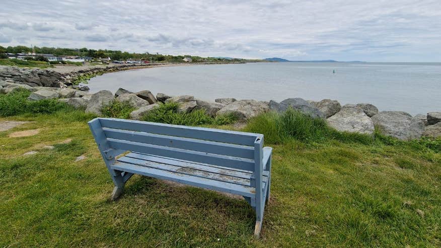 A blue bench looking out over the sea at Cahore Beach.