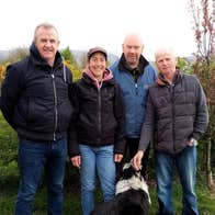 A tour group with a sheepdog