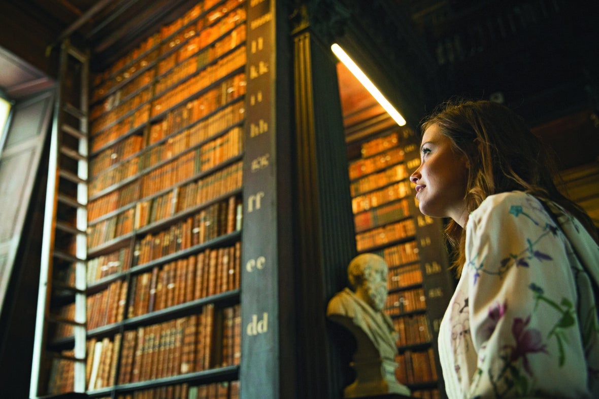 Girl admiring the books at Long Room of Trinity College, Dublin