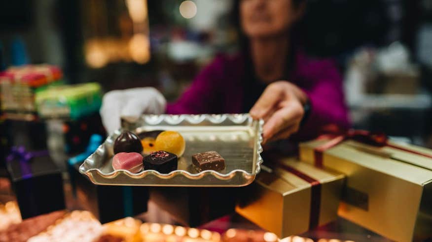 Woman holding a tray of chocolates at The English Market in Cork.