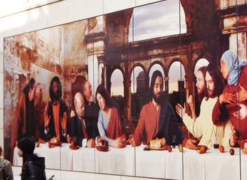 Street art image based on the last supper with people sitting on one side of a dinner table