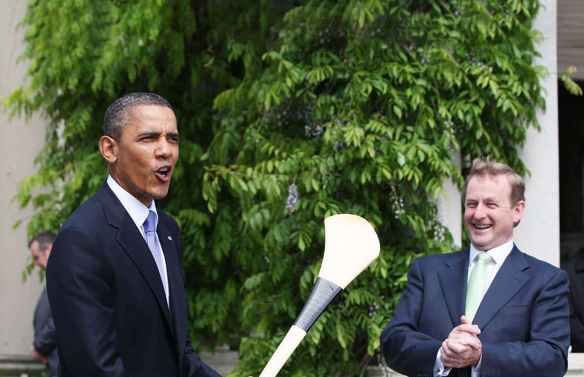 Barack Obama posing with a hurl alongside former Taoiseach Enda Kenny during his visit to Ireland in 2011