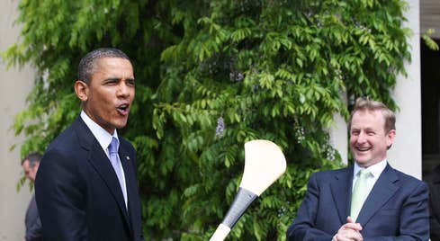 Barack Obama posing with a hurl alongside former Taoiseach Enda Kenny during his visit to Ireland in 2011