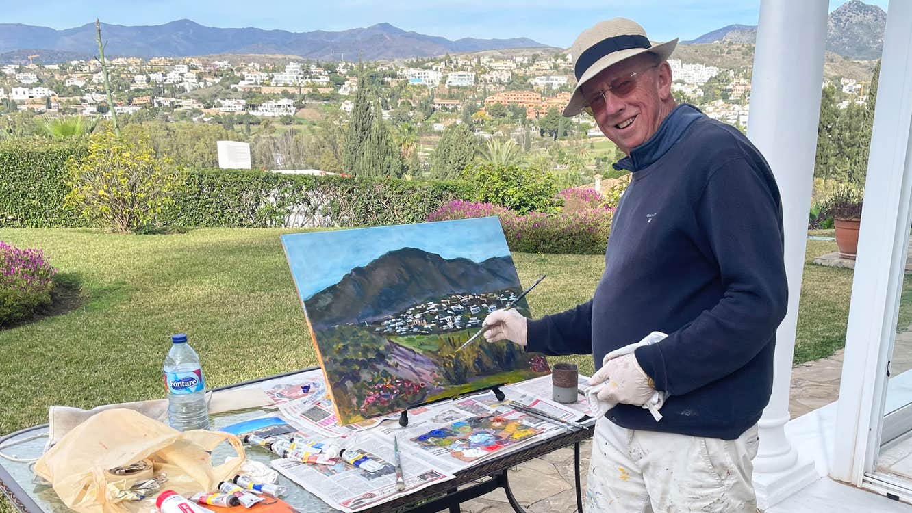 Michael Hanrahan Art view of the artist painting a landscape with mountains