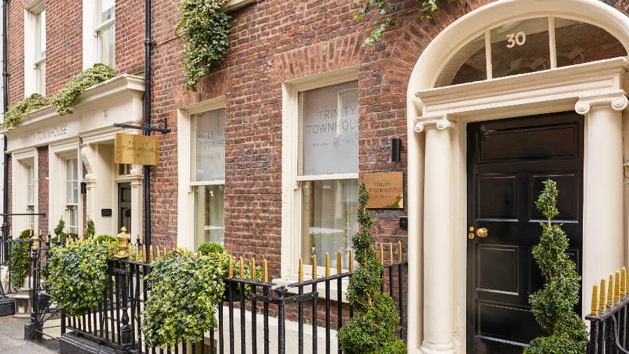 Red brick front wall with cream door
