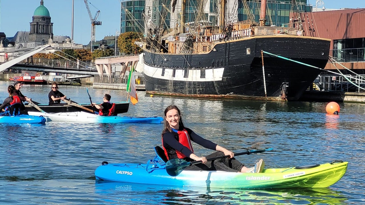 A group out kayaking on the River Liffey with the Jeannie Johnson famine ship in the background