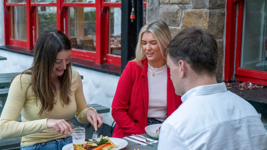 Three people eating at Larkins in Garrykennedy, County Tipperary.