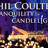 Phil Coulter - Tranquillity By Candlelight, a man seated at a pale grand piano with blurry lit candles in the foreground