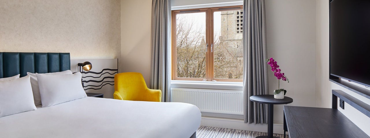 Double bed with white sheets