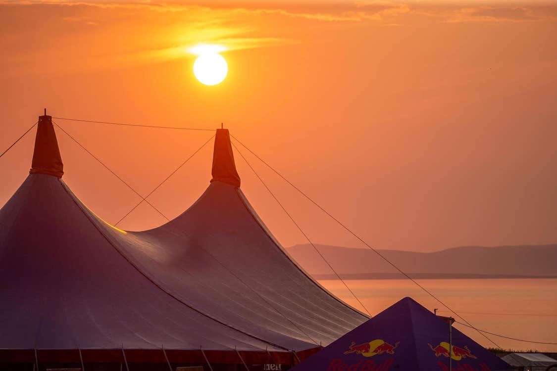 Beautiful sunset over the main stage tent at Sea Sessions Surf & Music Festival
