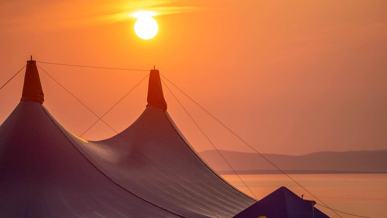 Beautiful sunset over the main stage tent at Sea Sessions Surf & Music Festival
