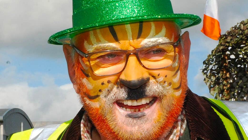 Roscrea Goes Green - St Patrick’s Day Parade, a man with painted orange cat face and sparkly green hat.