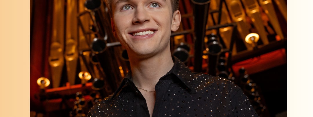 Poster for the event which features a smiling young man with the pipes of a large organ behind him.