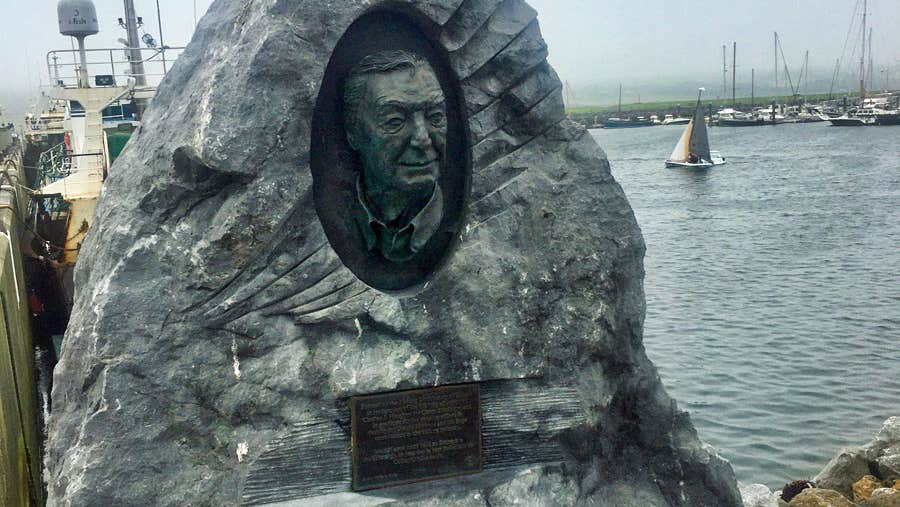 Bronze relief monument of Charles Haughey offset in limestone on the pier in Dingle County Kerry