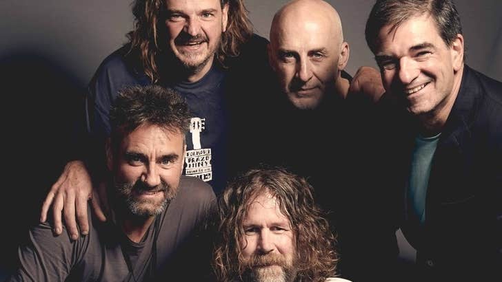 A tight group of 5 smiling men