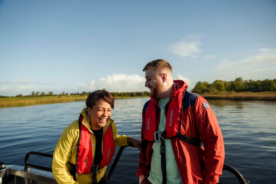 Couple laughing on a boat on Lough Ree.