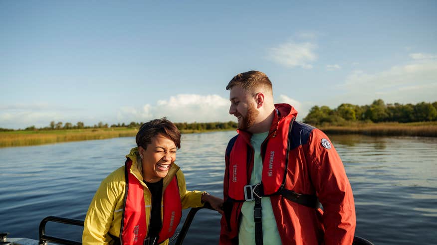 Couple laughing on a boat on Lough Ree.