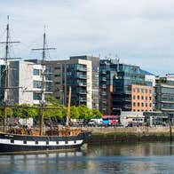 A view of the Jeanie Johnston docked on the Custom House Quay in Dublin's Docklands with a view of the Convention Centre in the background