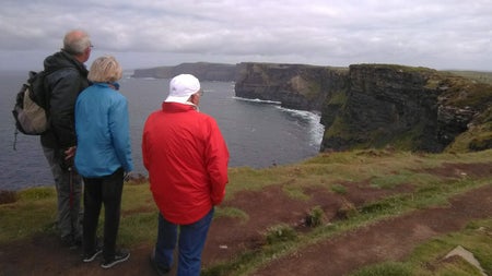 Group of three people looking at coast