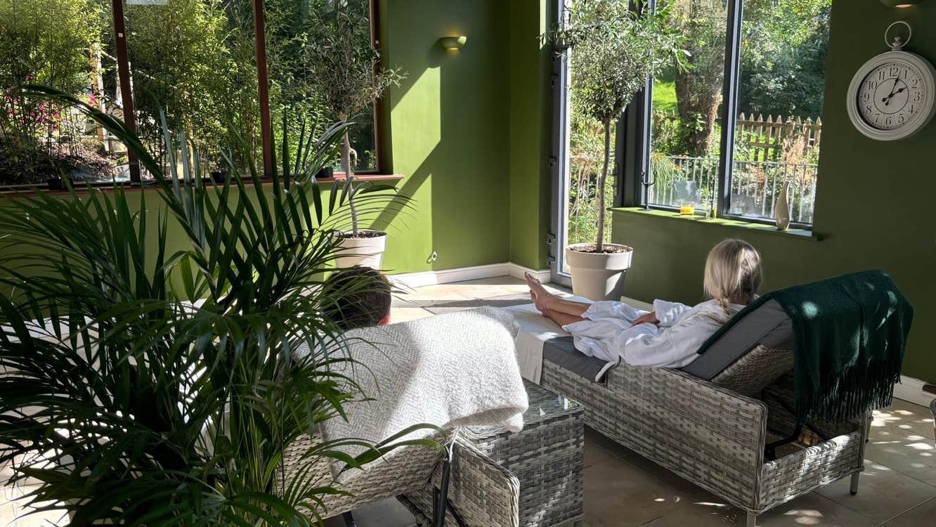 Two people lying on wicker lounges in a relaxation room in a spa