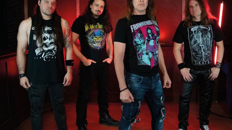 Group of 4 men in black T-shirts and long hair looking serious.