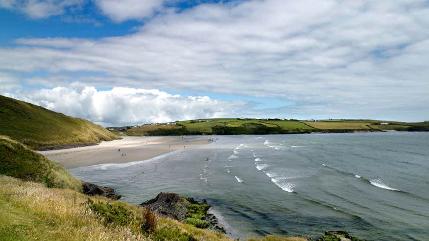 Waves on Inchydoney Beach in West Cork under green hills