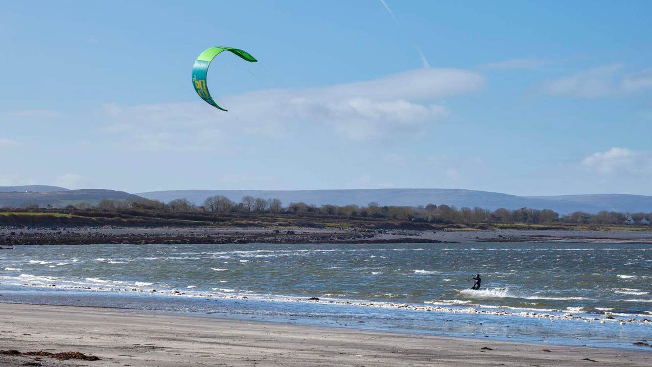 A kitesurfer in the sea at Traught Beach, Galway