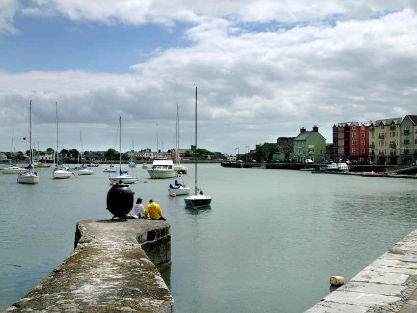 Two people sitting at Dungarvan Harbour in County Waterford.