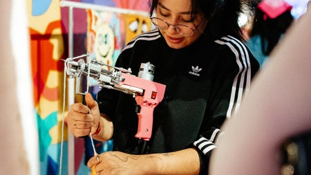 One of our expert instructors demonstrating how the tufting gun works on a large frame.