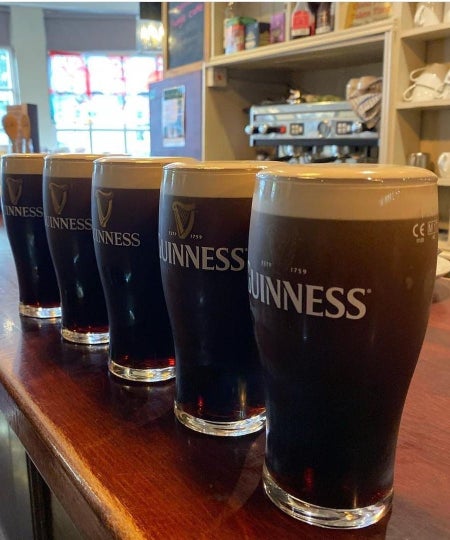 Five pints of Guinness lined up on the bar at The Patriot's Inn