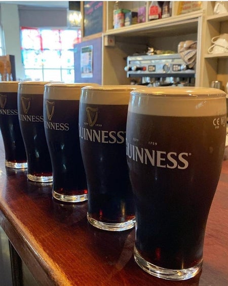 Five pints of Guinness lined up on the bar at The Patriot's Inn