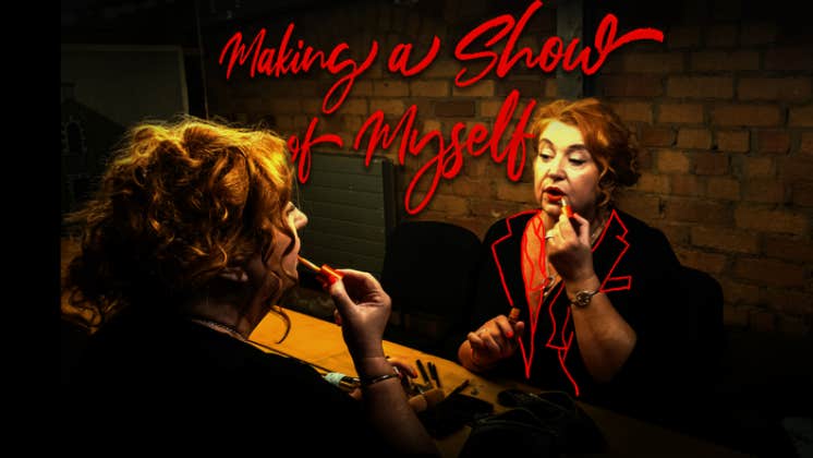 mary kate o flanagan in front of a dressing room mirror applying lipstick